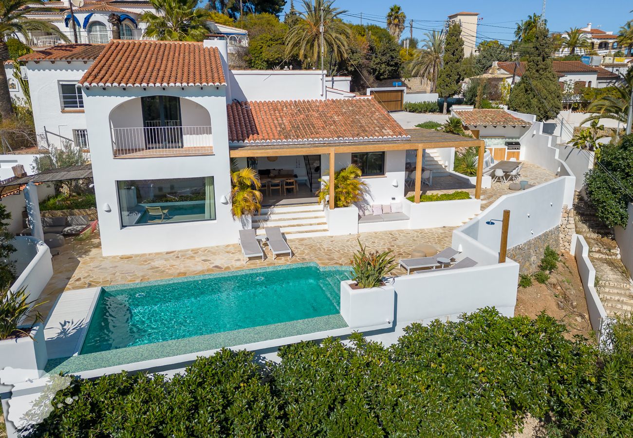 The front view of Casa Calmar with the Ibiza style garden and the crystal clear swimming pool!